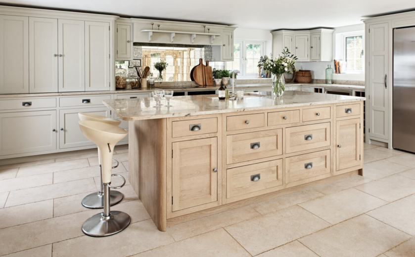 kitchen island with beige limestone worktops